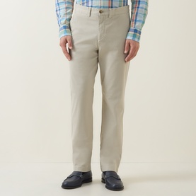 Model wearing Gant Classic Mid-Rise Straight Leg Chinos in clay beige, styled with a blue check shirt and navy loafers.
