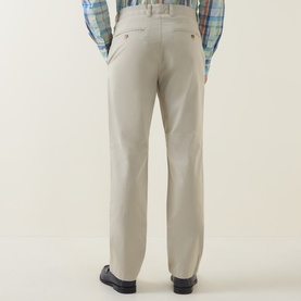 Model wearing Gant Classic Mid-Rise Straight Leg Chinos in clay beige, straight-cut fit, styled with a plaid shirt and dark loafers.