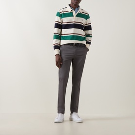 Model wearing Gant Dusky Anthracite slim chinos styled with a green striped rugby polo and white trainers.