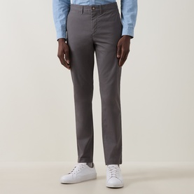 Model wearing Gant Dusky Anthracite slim-fit cotton chinos, styled with a light blue shirt and white trainers.