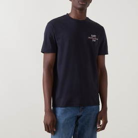 Model wearing Gant Evening Blue cotton crew neck T-shirt with chest logo print, styled with blue jeans.