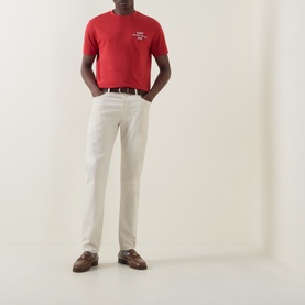Model wearing Gant 1949 Logo T-Shirt in Maple Fire red with white chinos and brown leather loafers