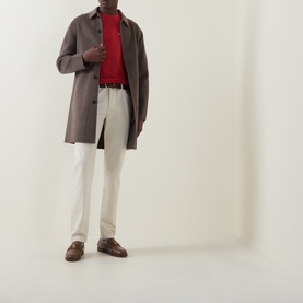 Model wearing Gant 1949 Logo T-Shirt in Maple Fire, styled with grey overcoat, cream trousers and brown loafers.