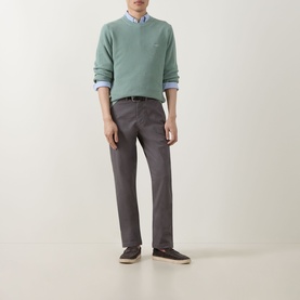 Model wearing Gant Surplus Mint crew neck jumper, styled with light blue shirt, grey trousers and dark canvas shoes.