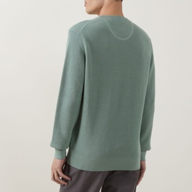 Model wearing Gant Surplus Mint crew neck knit, rear view, paired with grey trousers