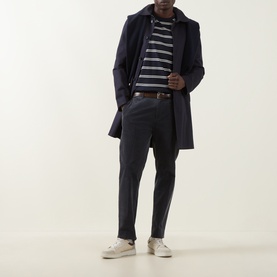 Model wearing Gant Pima Striped T-Shirt in Evening Blue with navy overcoat, dark trousers, and white trainers.