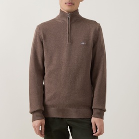 Model wearing Gant Dark Hazelnut Melange half-zip knit sweater with ribbed hem and cuffs, styled with dark trousers.