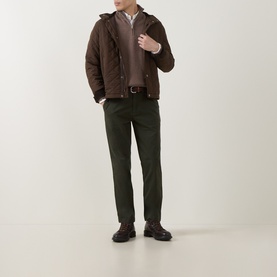 Model wearing Gant Dark Hazelnut Melange Half Zip, styled with brown hooded jacket, dark green trousers and brown boots.