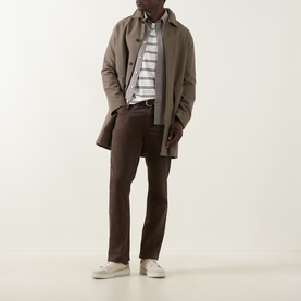 Model wearing Gant Cream Crew Neck T-shirt styled with taupe mac coat, dark brown trousers and white trainers.