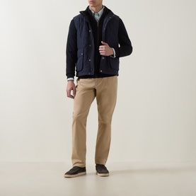Model wearing Gant Classic Diamond Quilted Gilet in Evening Blue, styled with a shirt, chino trousers and dark espadrilles.