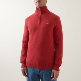 Model wearing Gant Maple Fire cotton half-zip jumper with ribbed cuffs and hem, small shield logo on chest, paired with blue jeans