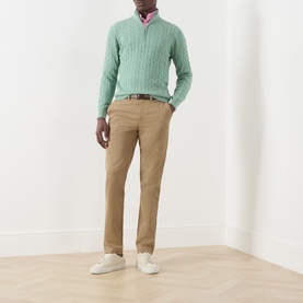 Model wearing Gant Soft Green Melange cotton cable-knit half-zip jumper, styled with tan chinos and white trainers.