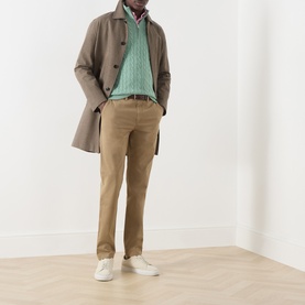 Model wearing Gant Soft Green Melange Cotton Half Zip, styled with a brown overcoat, tan chinos and white trainers.