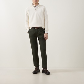 Model wearing Gant Logo Textured Half-Zip Sweater in cream, styled with dark olive trousers and brown boots.