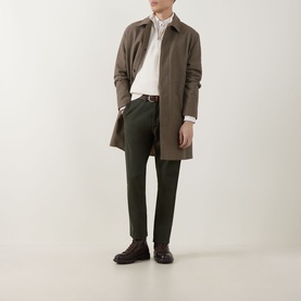 Model wearing Gant Logo Textured Half-Zip Sweater in Cream, styled with khaki mac coat, dark green trousers and brown leather shoes.