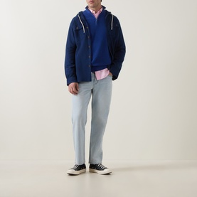 Model wearing Gant Shield Logo Half-Zip Micro Textured Sweatshirt in Crisp Blue, styled with light blue jeans and pink shirt.