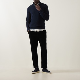 Model wearing Gant Shield Half-Zip Textured Sweater in Evening Blue with waffle knit texture, styled with check shirt and black trousers.