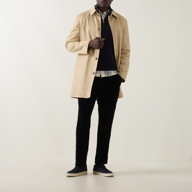 Model wearing Gant Shield Half-Zip Textured Sweater in Evening Blue, styled with a sand mac coat, grey shirt and black trousers.