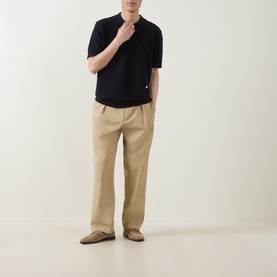 Model wearing Gant Evening Blue cotton knit polo with beige chinos and tan suede loafers.