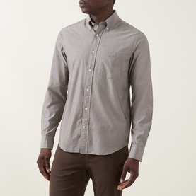 Model wearing Gant Brown Melange Reg Shirt in cotton, button-down collar with chest pocket, styled with brown trousers
