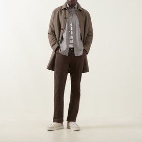 Model wearing Gant Brown Melange Reg Shirt, styled with a taupe overcoat, dark brown trousers and white trainers.