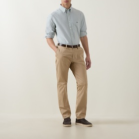 Model wearing Gant Shield Logo Oxford Shirt in Surplus Mint with button-down collar, styled with tan chinos and a brown belt.