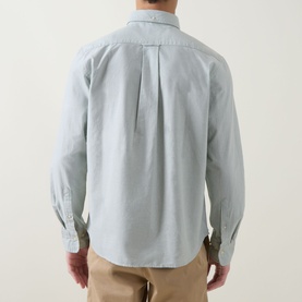 Model wearing Gant Shield Logo Oxford Shirt in Surplus Mint, back view showing box pleat, long sleeves, styled with beige chinos.