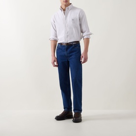 Model wearing Gant Light Taupe Reg Shirt in cotton, styled with dark indigo jeans and brown lace-up shoes.