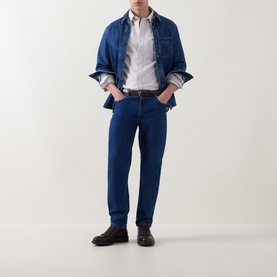 Model wearing Gant Light Taupe Reg Shirt in 100% cotton, styled with dark blue jeans, denim jacket and brown leather shoes.