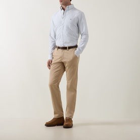 Model wearing Gant Shield Logo Striped Shirt in Surplus Mint with button-down collar, styled with tan chinos and brown suede shoes.