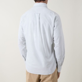 Model wearing Gant Shield Logo Striped Shirt in Surplus Mint, rear view, long sleeves, styled with beige trousers.