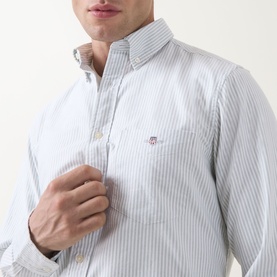 Model wearing Gant Shield Logo Striped Shirt in Surplus Mint, button-down collar, embroidered shield logo on chest, long sleeves
