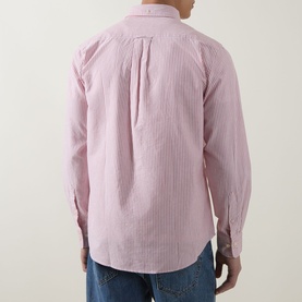 Model wearing Gant Shield Logo Striped Shirt in Maple Fire pink stripe, back view, with blue jeans visible.