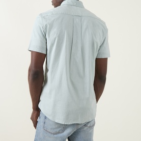 Model wearing Gant Shield Logo Shirt in Surplus Mint, short sleeves, back view, styled with light blue jeans