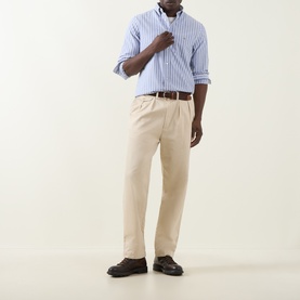 Model wearing Gant Shield Logo Striped Shirt in College Blue with beige chinos, brown leather belt and dark loafers.