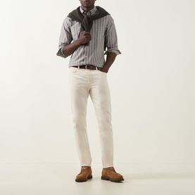 Model wearing Gant Logo Striped Shirt in brown melange with cream trousers, brown belt and suede derby shoes