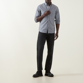 Model wearing Gant Logo Striped Shirt in dark indigo melange with button-down collar and chest pocket, styled with dark trousers and black shoes.