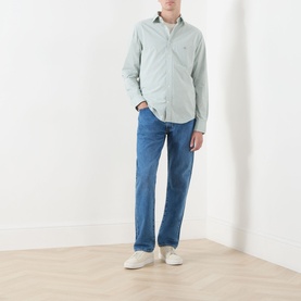 Model wearing Gant Classic Gingham Shirt in Surplus Mint with blue jeans and white trainers.