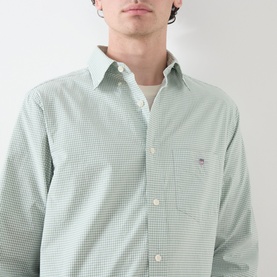 Model wearing Gant Classic Gingham Shirt in Surplus Mint, featuring button-down collar, chest pocket and embroidered shield logo. Layered over white