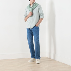 Model wearing Gant Classic Gingham Shirt in Surplus Mint, styled with blue straight-leg jeans and white trainers