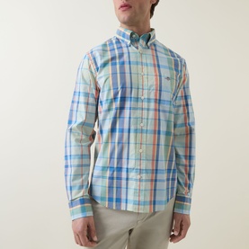 Model wearing Gant Shield Logo Checked Casual Shirt in Misty Mint multicolour plaid, long sleeves, patch chest pocket, styled with beige trousers.
