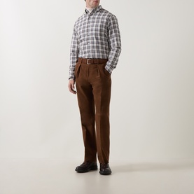 Model wearing Gant Sand Reg Shirt in plaid check, styled with brown trousers and dark shoes.