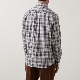 Model wearing Gant Reg Shirt in sand check, rear view showing plaid pattern, button cuffs, styled with brown trousers.