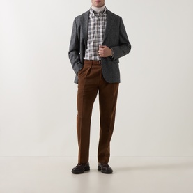 Model wearing Gant sand check reg shirt, styled with grey blazer, brown trousers and dark loafers.
