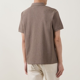 Model wearing Gant Regular Polo in Dark Hazelnut Melange, short sleeves, rear view, styled with cream trousers.