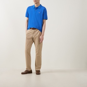 Model wearing Gant Nautical Blue Regular Polo with khaki chinos and brown leather shoes.