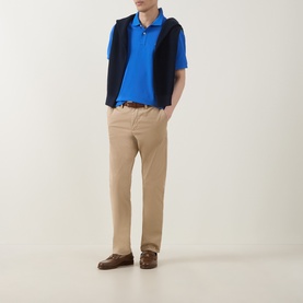 Model wearing Gant Nautical Blue Regular Polo with navy gilet, beige chinos and brown loafers.
