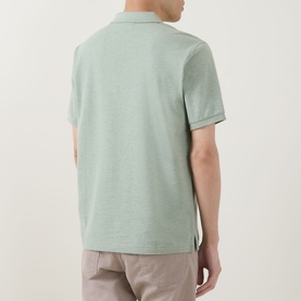 Model wearing Gant Regular Polo in soft green melange cotton, rear view, styled with stone chinos.