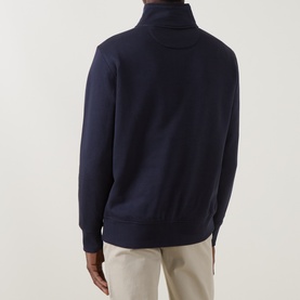 Model wearing Gant Evening Blue cotton-blend sweatshirt, back view showing roll neck and zip placket, styled with beige trousers.