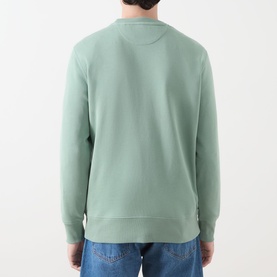 Model wearing Gant Shield Logo Sweatshirt in Surplus Mint, rear view, round neck, ribbed cuffs and hem, styled with blue jeans.